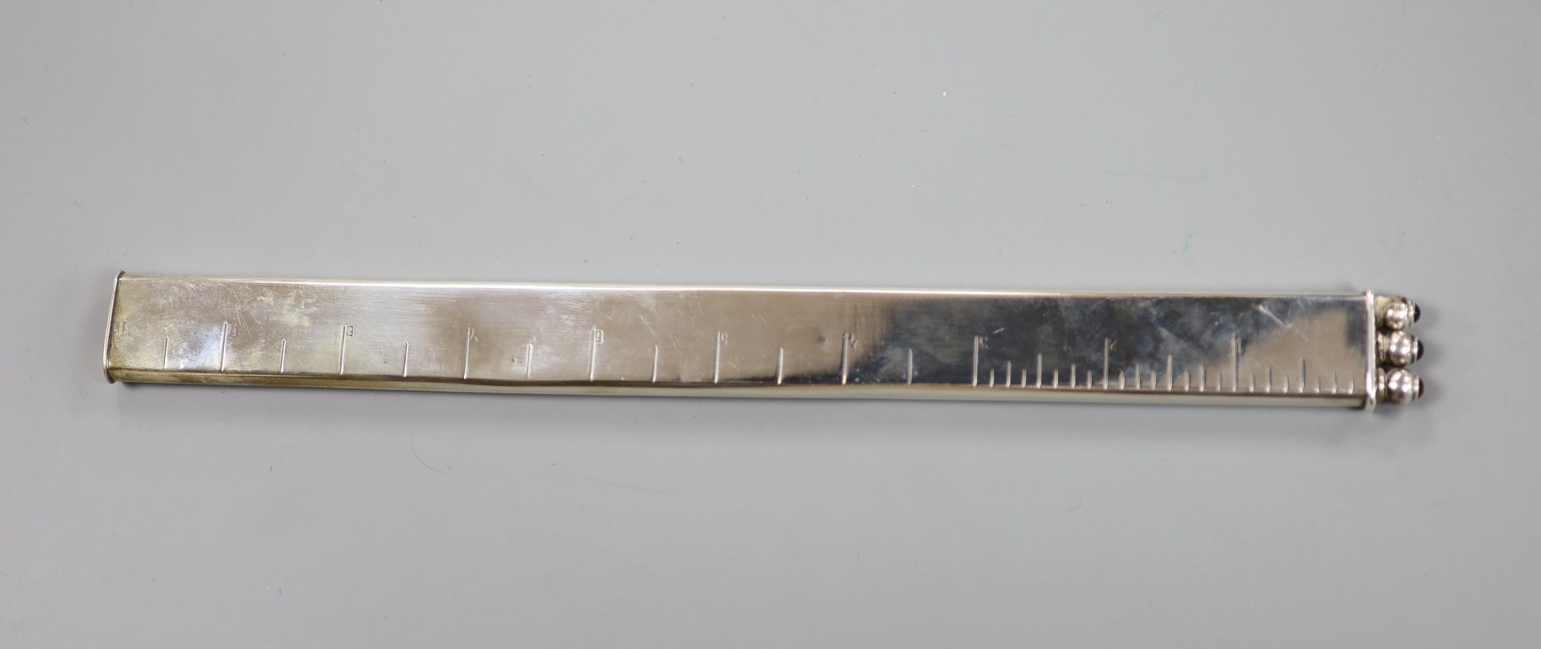 A late Victorian silver ruler and triple pen set, import marks for Heinrich Levinger, Birmingham, 1899, 26.2cm.